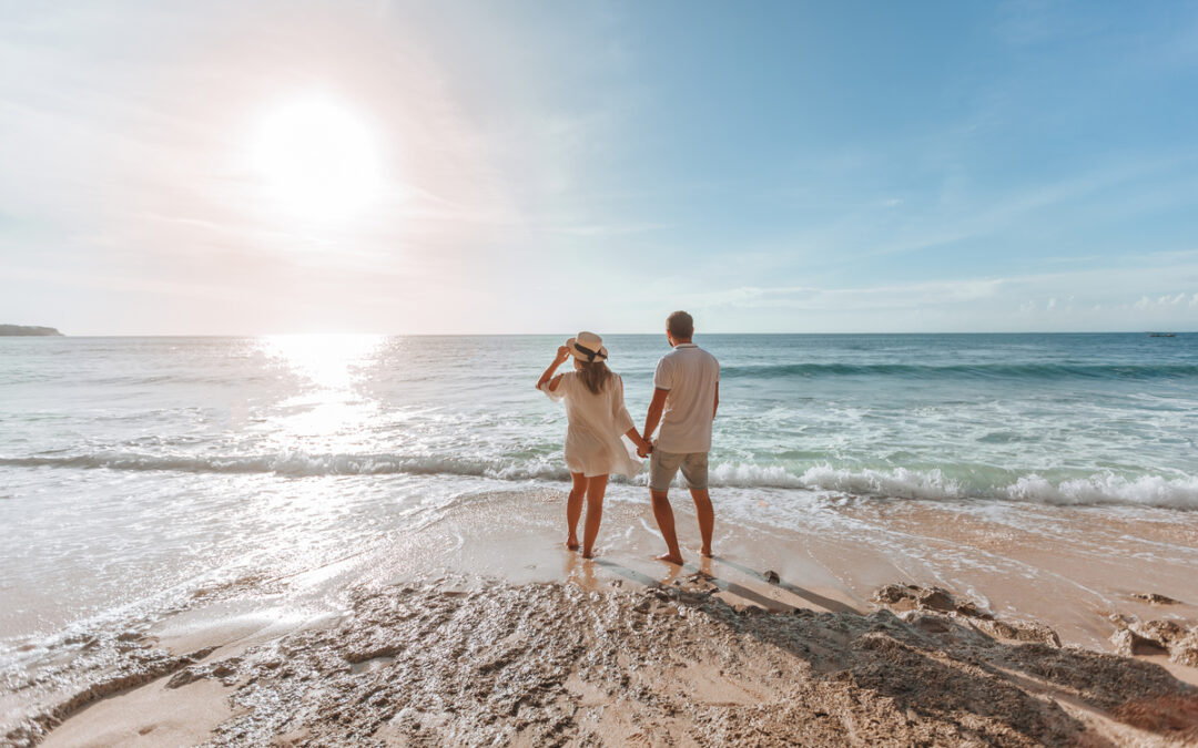 man-woman-hold-hands-watch-sunset-beach-1-1080x675.jpg